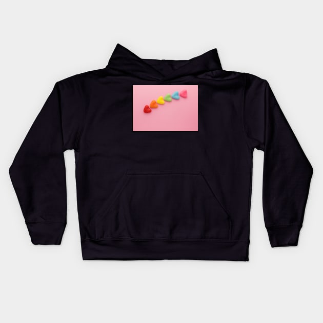 A variety of colorful candy hearts, in a rainbow shape, on a light pink background. Kids Hoodie by karinelizabeth